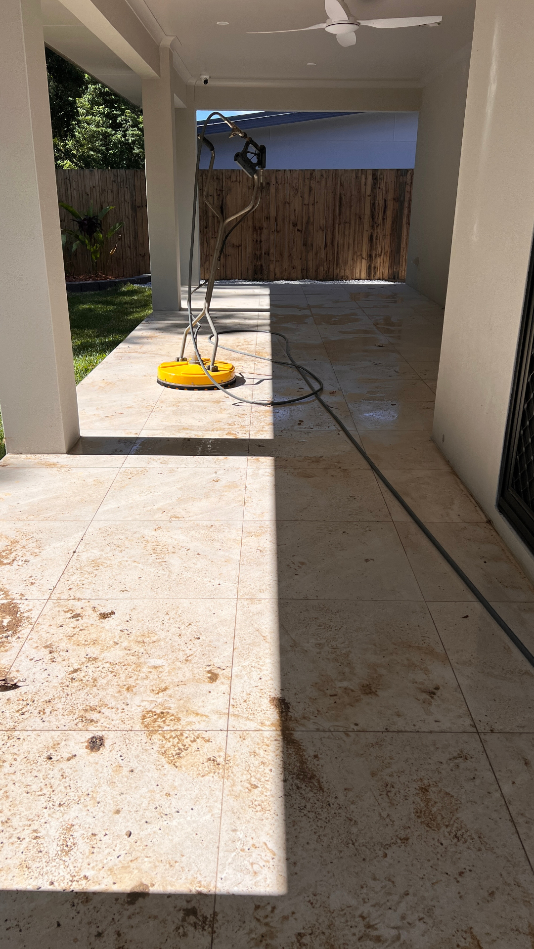 Dirty outdoor tiled patio before pressure washing