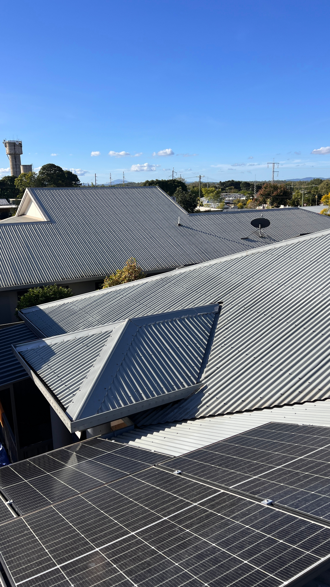 Clean corrugated metal roof across multiple sections of a Cairns property