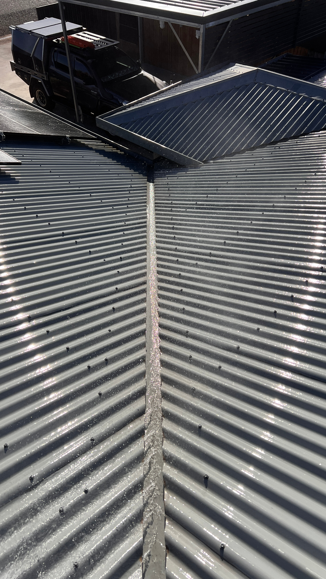 Cleaned corrugated roof valley after pressure washing