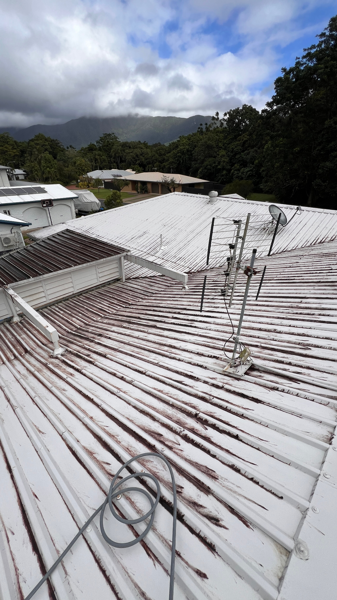 Rust-streaked metal roof before soft washing